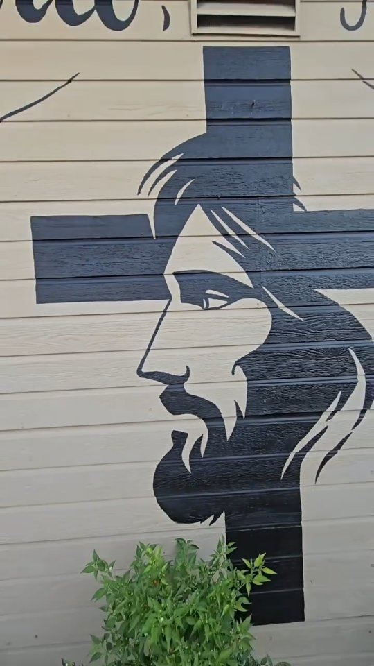 The finished mural: the face of Christ painted inside a black cross