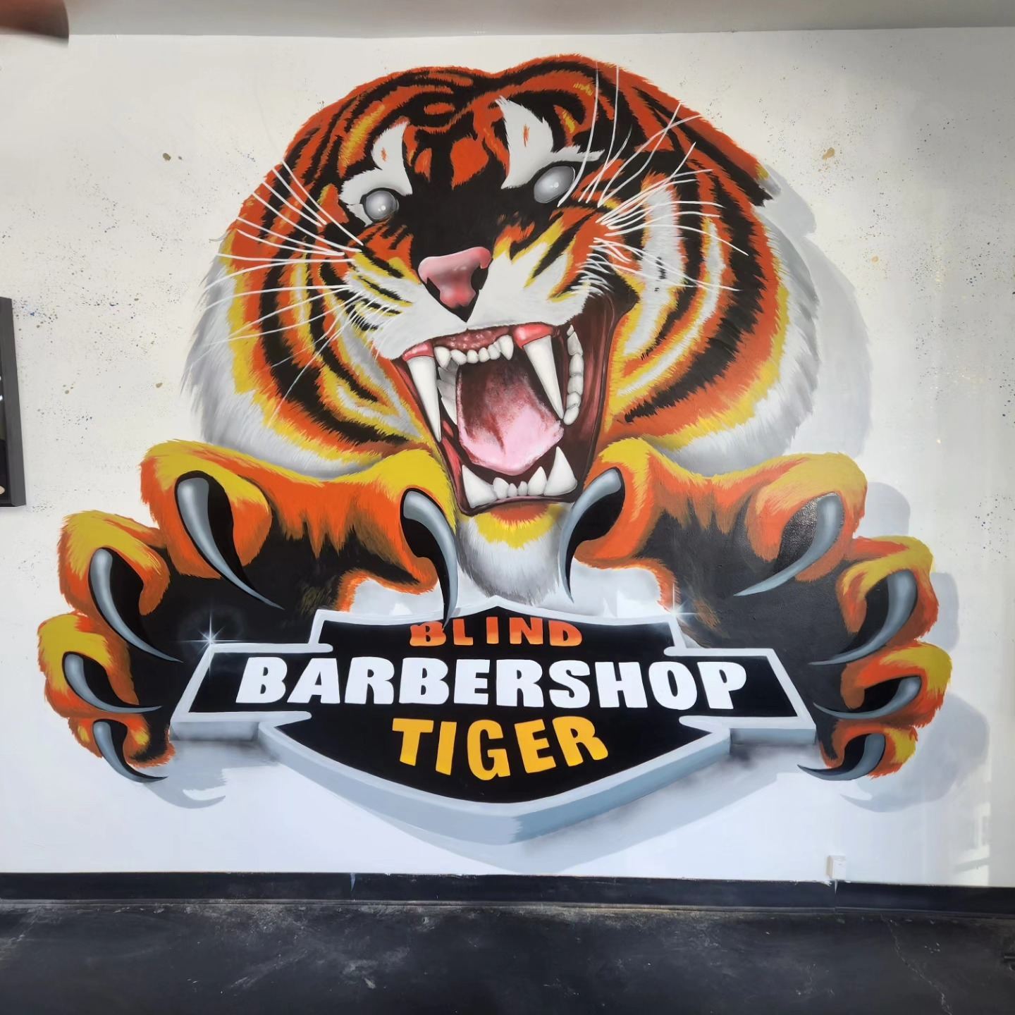 Snarling tiger barbershop mural painted across an interior wall